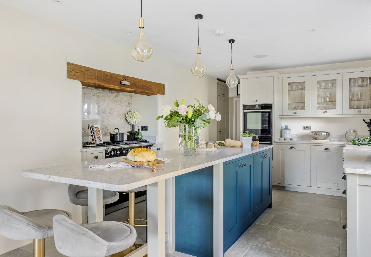White kitchen featuring blue island