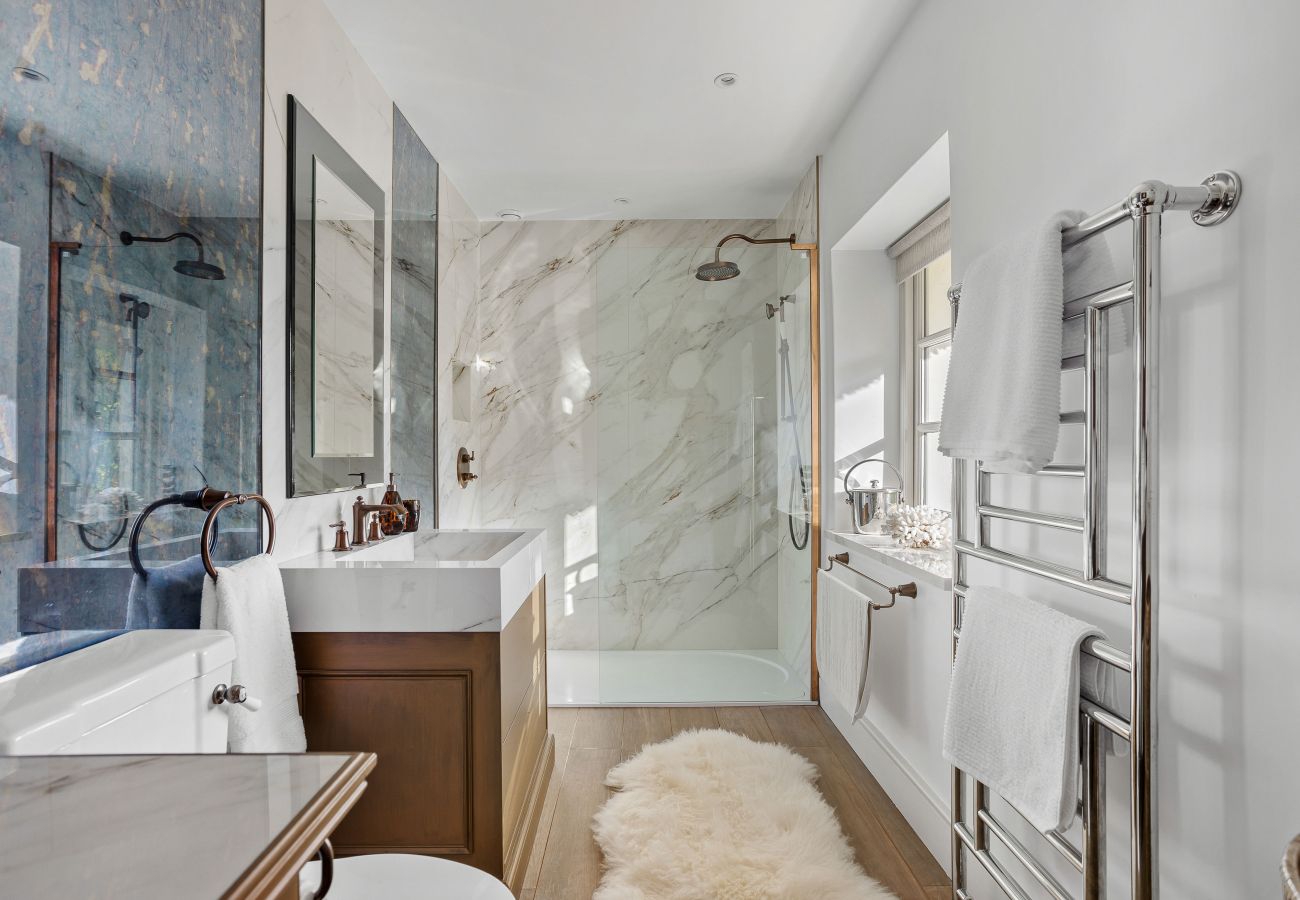 Glass shower with marble-style walls
