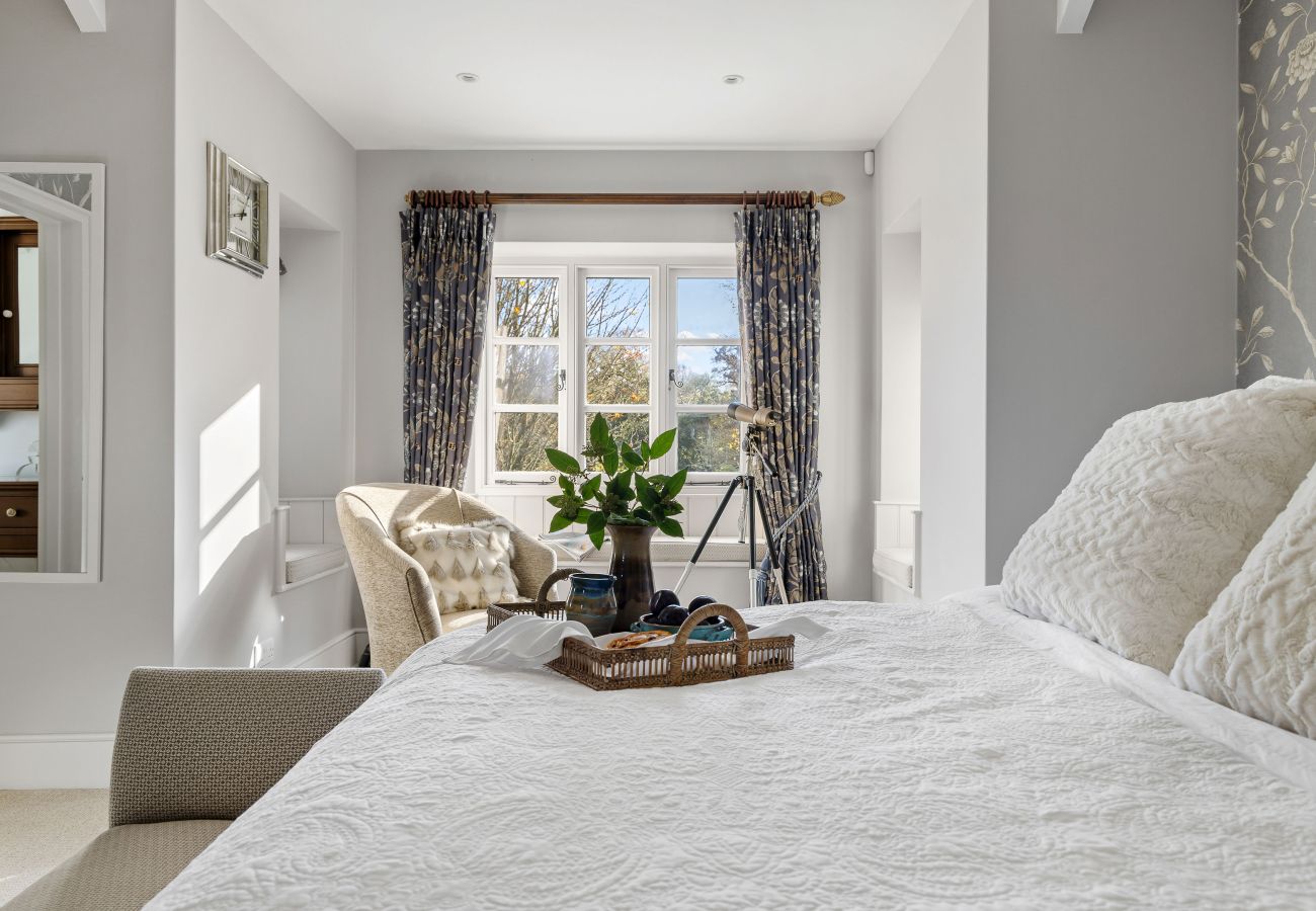 Armchair and table in bright bedroom corner