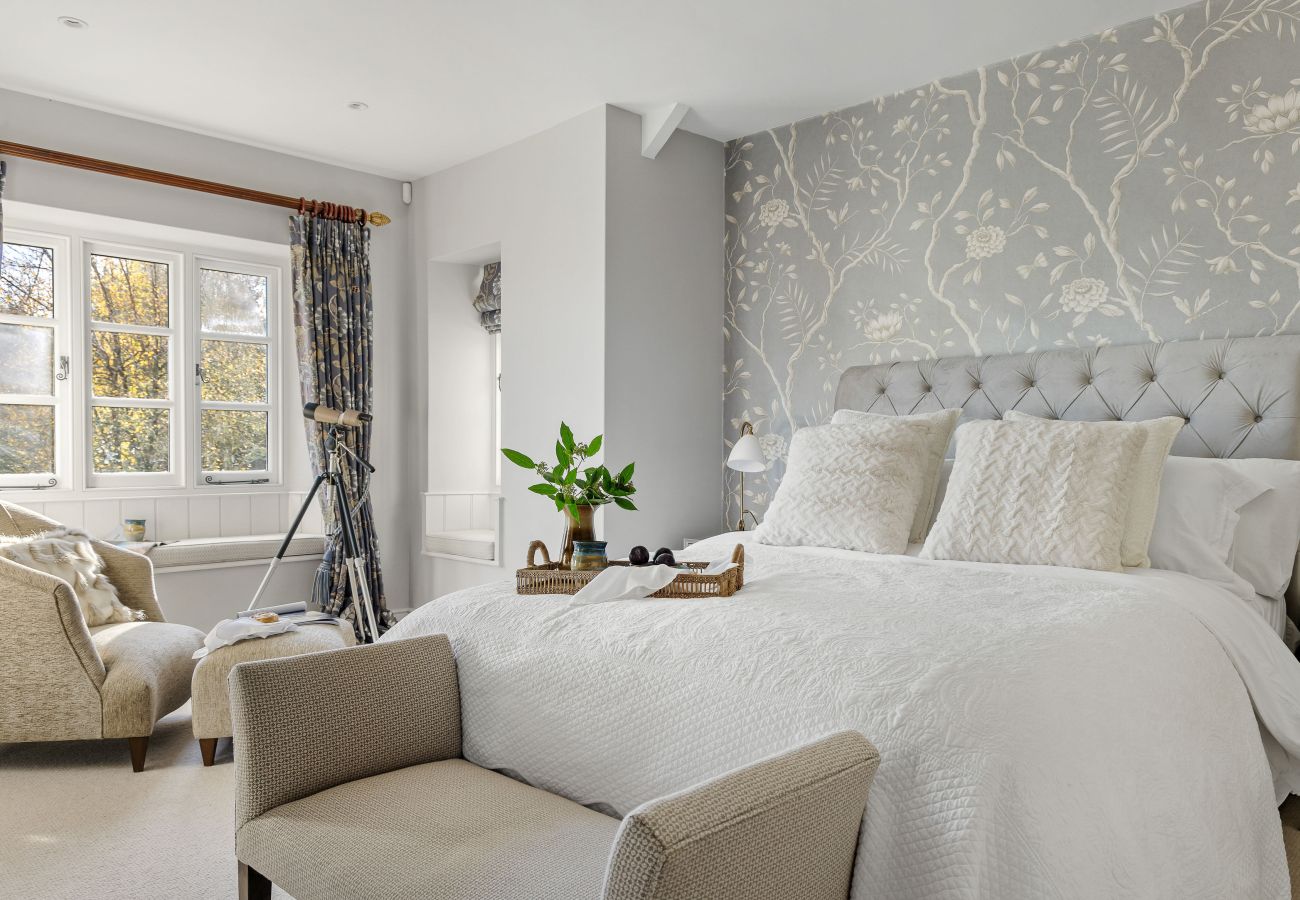Armchair and table in bright bedroom corner