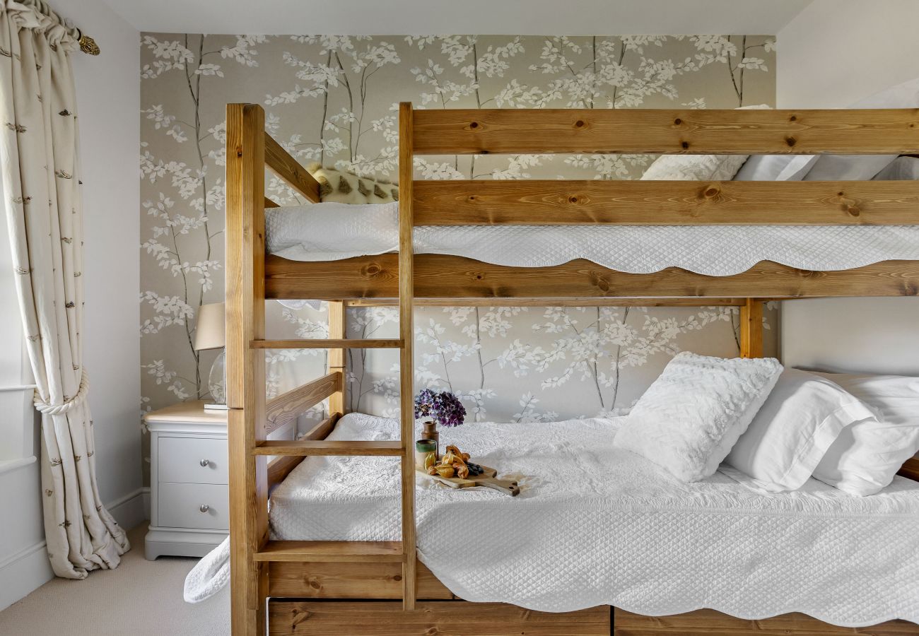 Wooden bunk beds in cosy bedroom