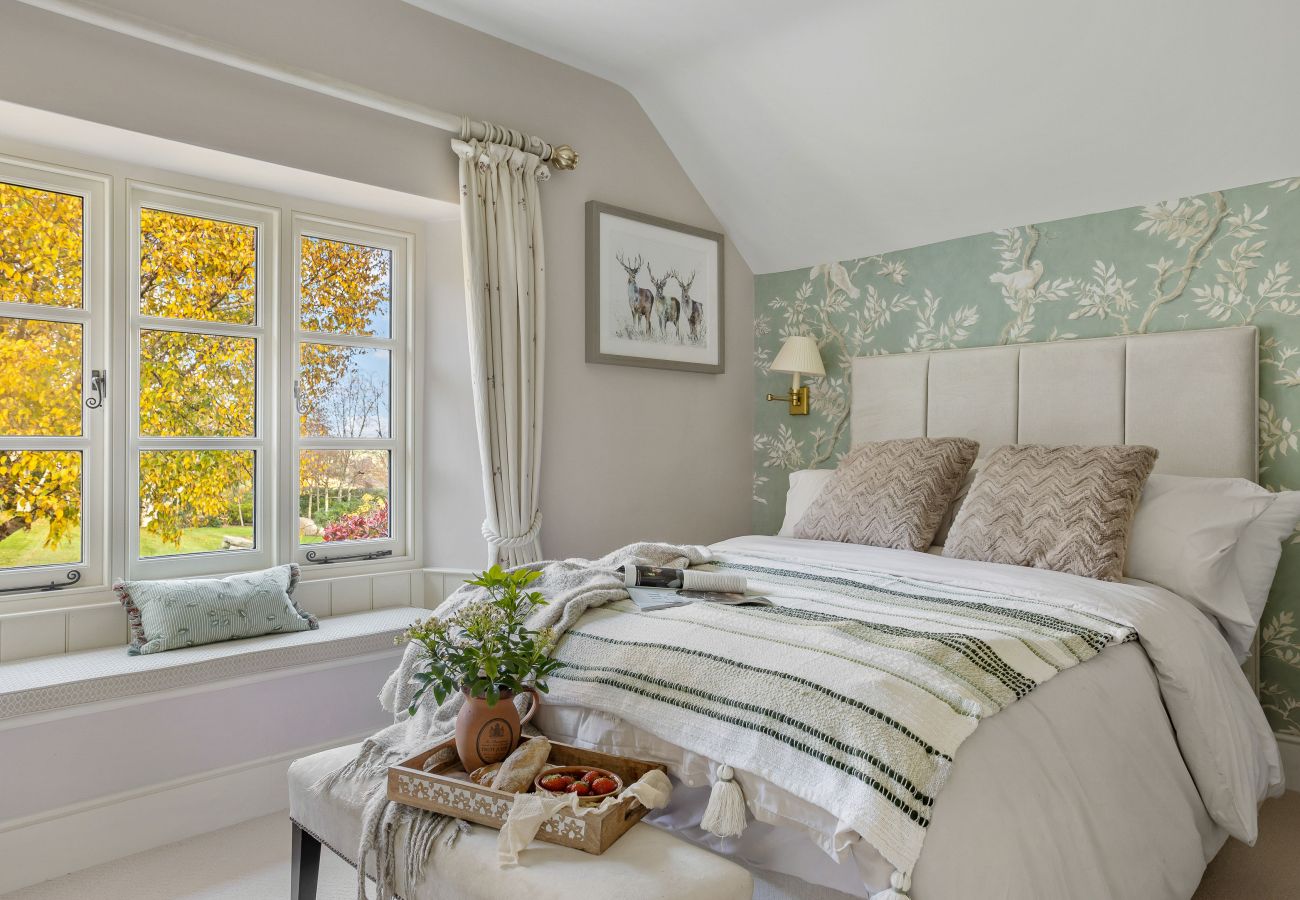 Twin beds against green feature wall