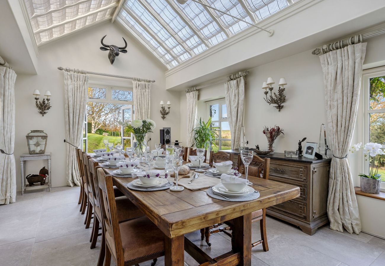 Elegant dining room for 8 people, looking out to garden.