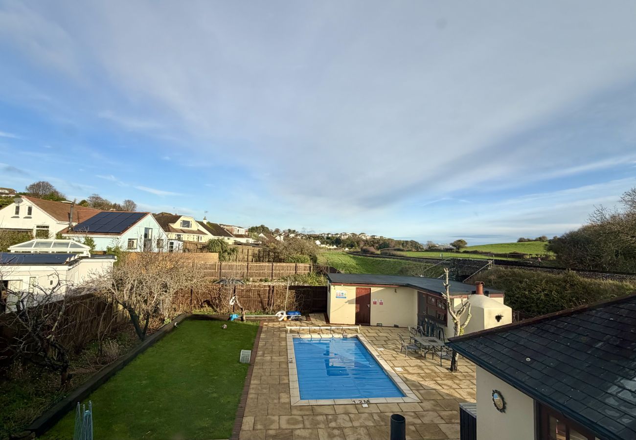 Private garden with outdoor swimming pool at Pheasants Haunt holiday home in Paignton