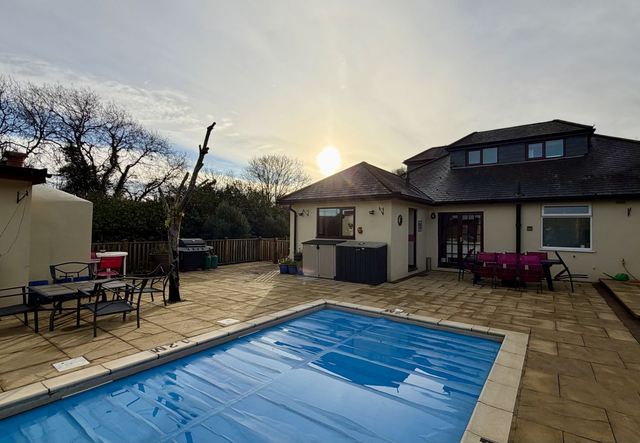 Private heated outdoor swimming pool and sun terrace at Pheasants Haunt holiday home in South Devon