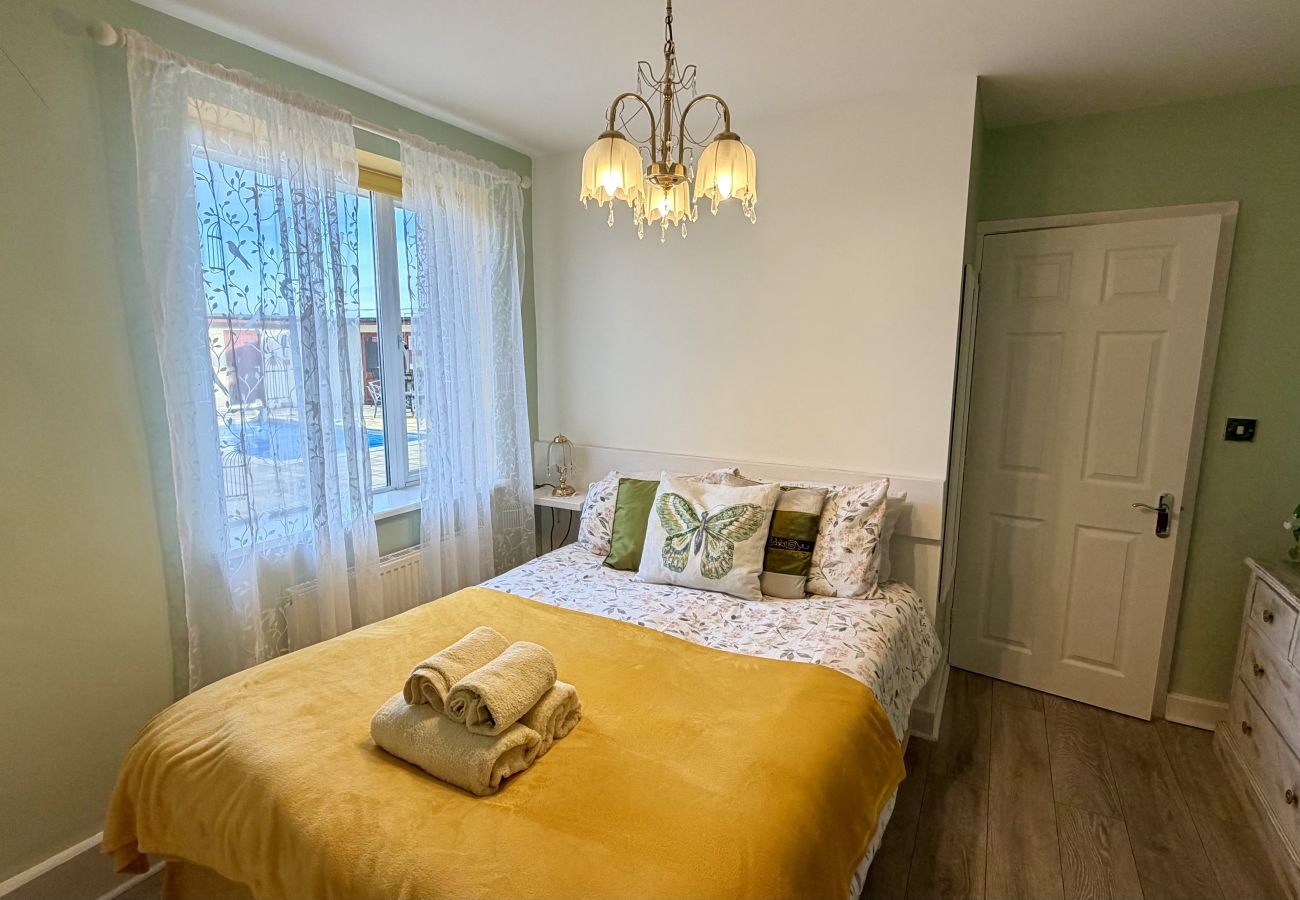 Bright double bedroom with window and soft furnishings at Pheasants Haunt holiday let in Devon