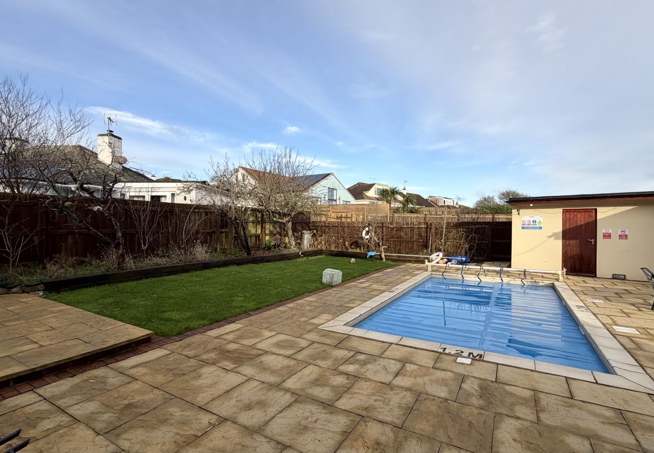 Private garden with outdoor swimming pool at Pheasants Haunt holiday home in Paignton