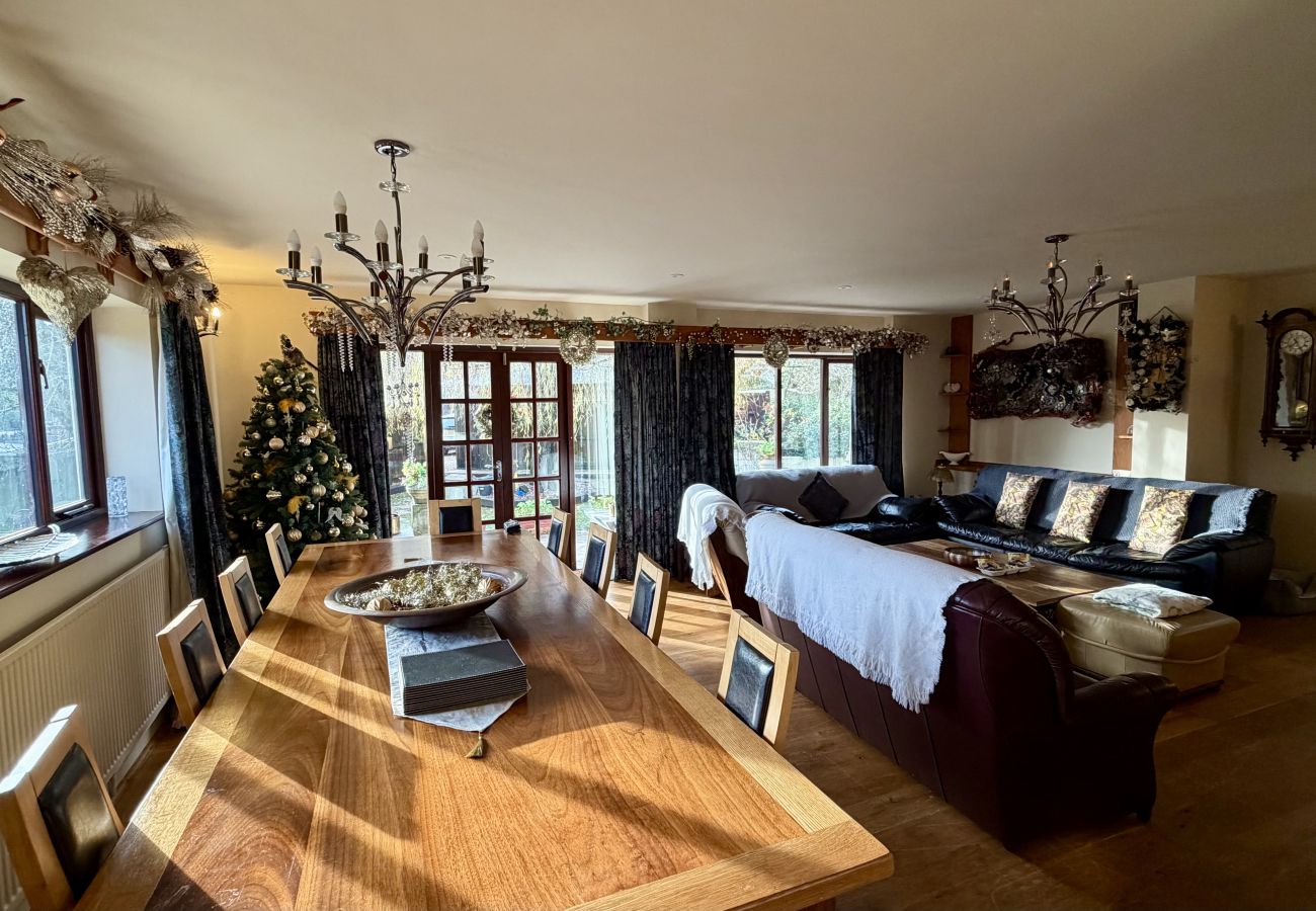 Dining area with large table for group meals at Pheasants Haunt family holiday home in Paignton