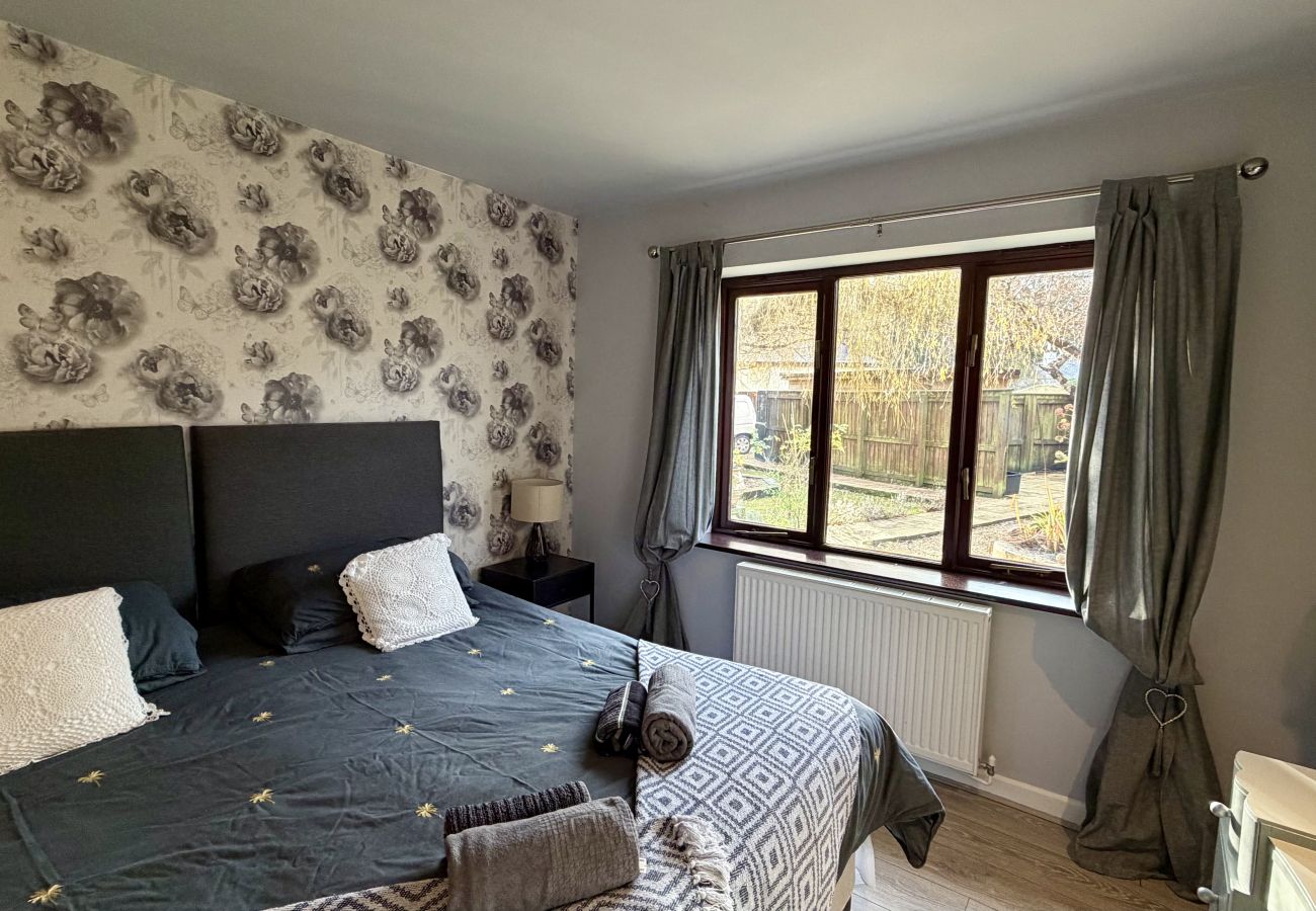 Stylishly furnished bedroom with natural light at Pheasants Haunt coastal holiday home