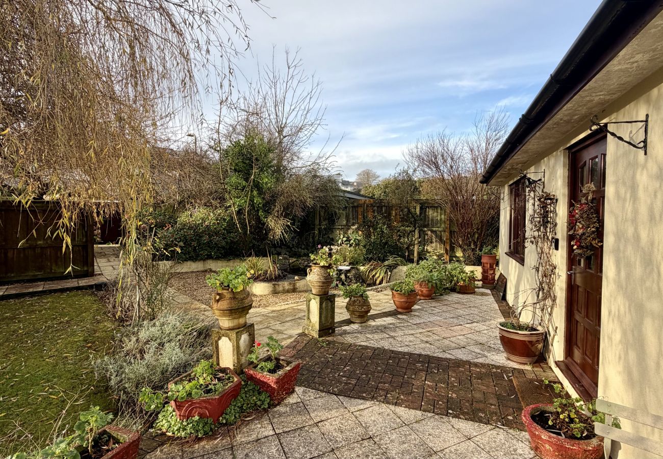Garden patio with plants and seating at Pheasants Haunt holiday home