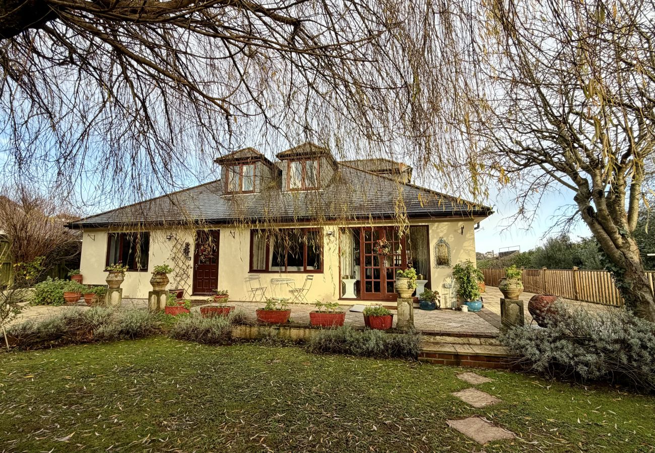 Front exterior of Pheasants Haunt, a large coastal holiday home in Paignton, South Devon surrounded by mature gardens