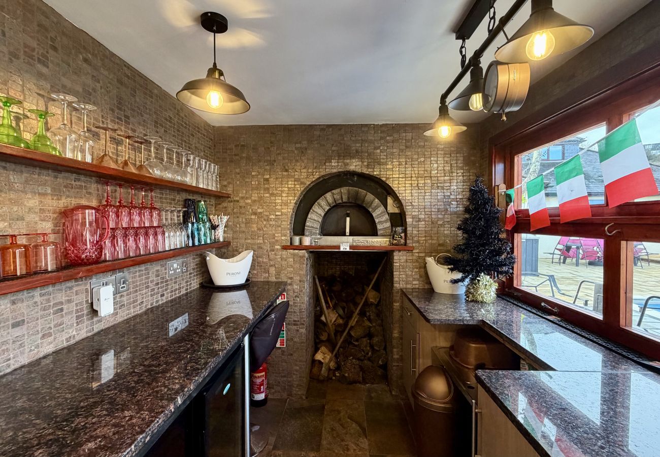 Interior of outdoor bar with seating and décor at Pheasants Haunt holiday home