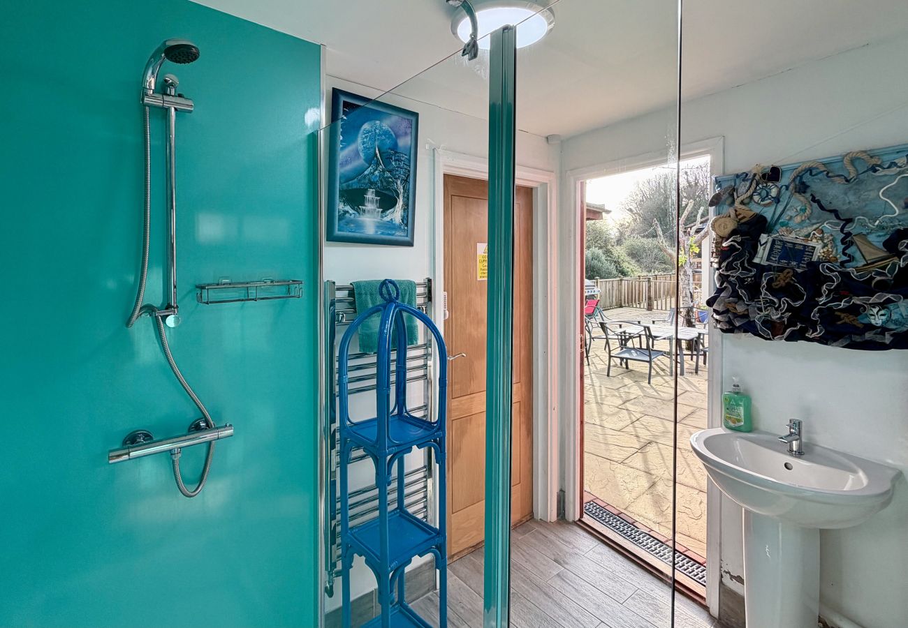 Shower room with glass enclosure near pool at Pheasants Haunt holiday home