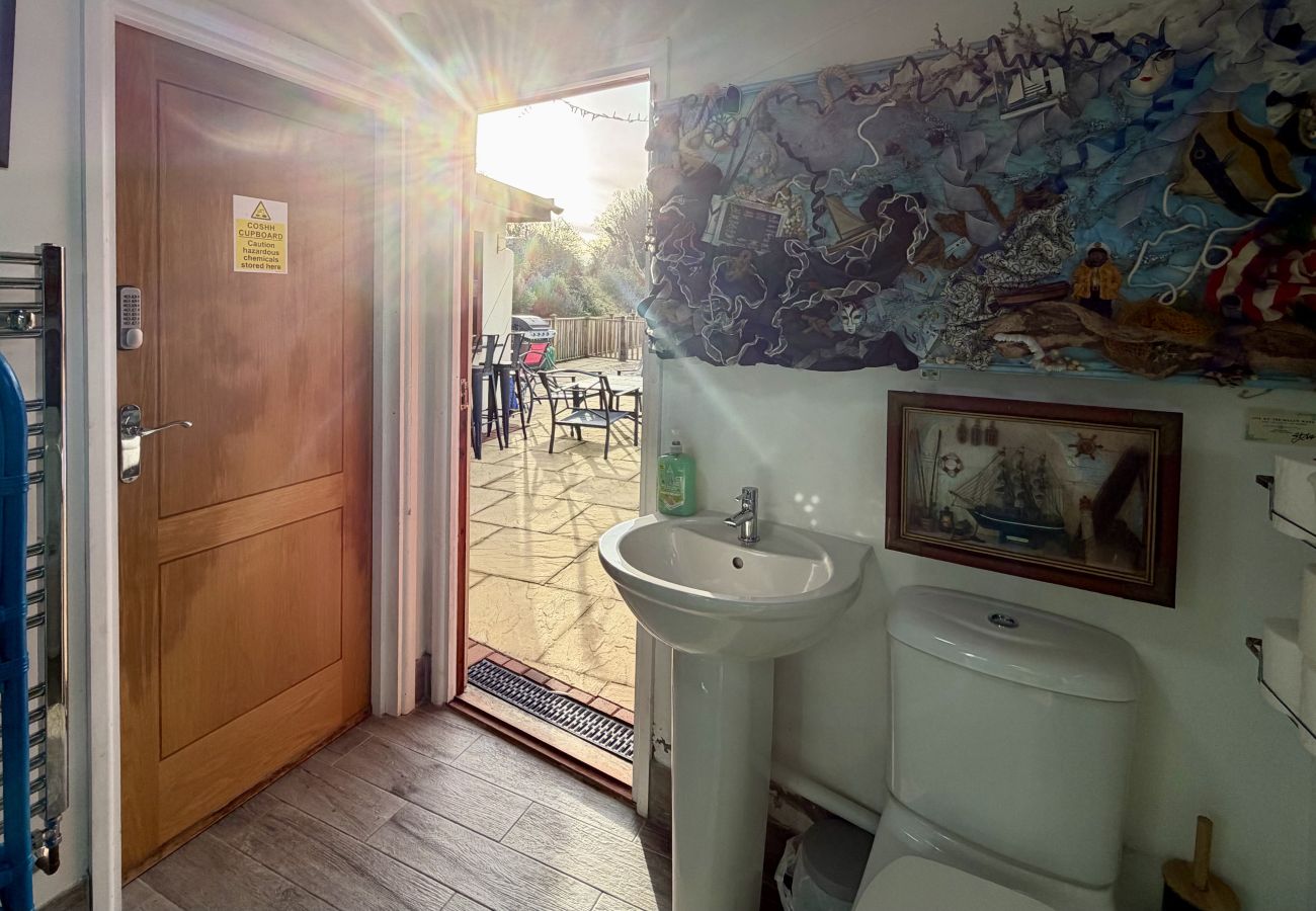Shower room with glass enclosure near pool at Pheasants Haunt holiday home