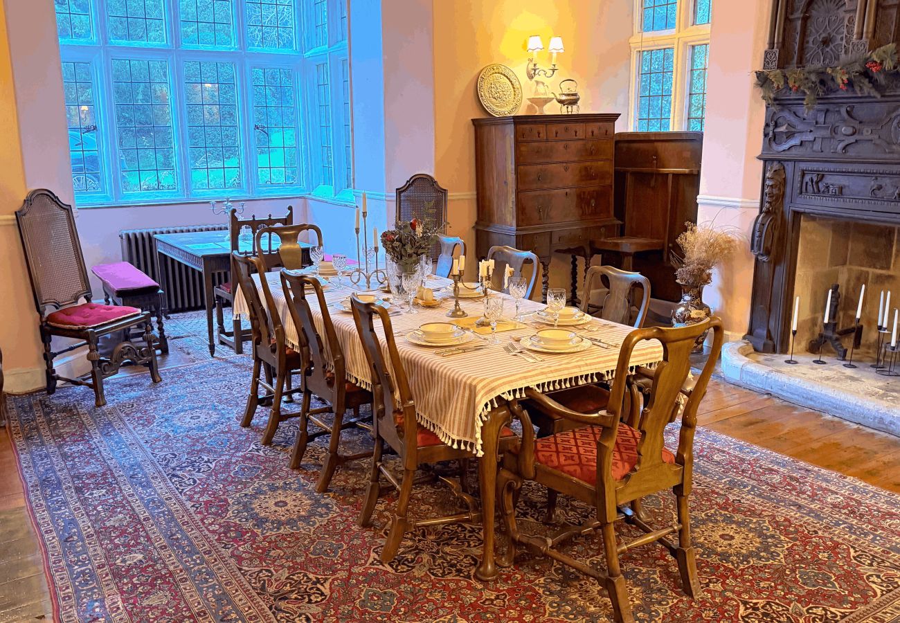 Interior of dining room at Haremere Hall showcasing a Jacobean oak fireplace